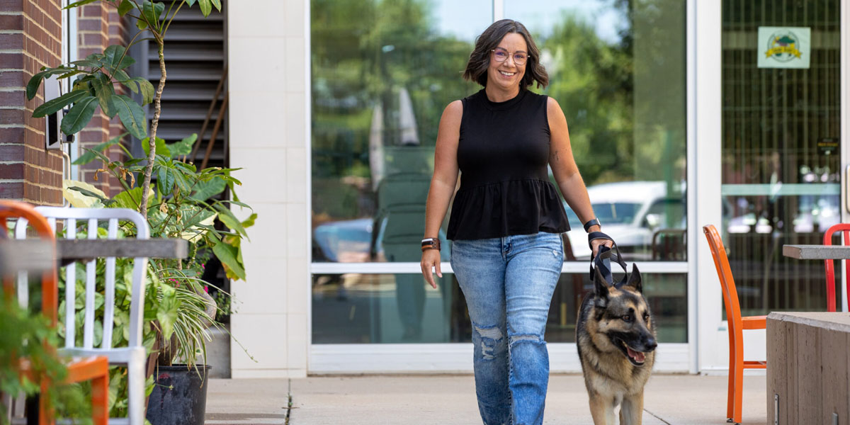 Devin McGrew walking dog in Downtown Sioux Falls