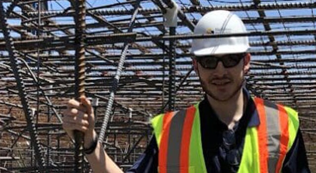 A photo of Jeremy Feist standing in a rebar structure