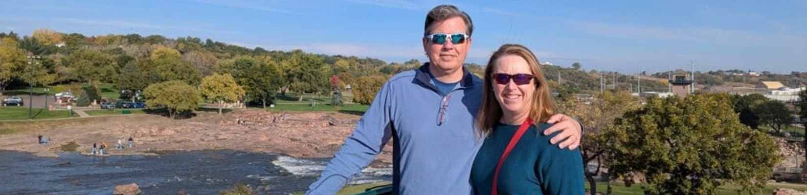 A photo of a man and a woman standing at an overlook of the Falls in Sioux Falls, SD